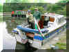 Brian & Wynne Gray from Llansadwrn, aboard their pleasure craft ` Viking `  enoying their visit tio the 5 Locks moorings, Pontnewydd. May 26th 2004